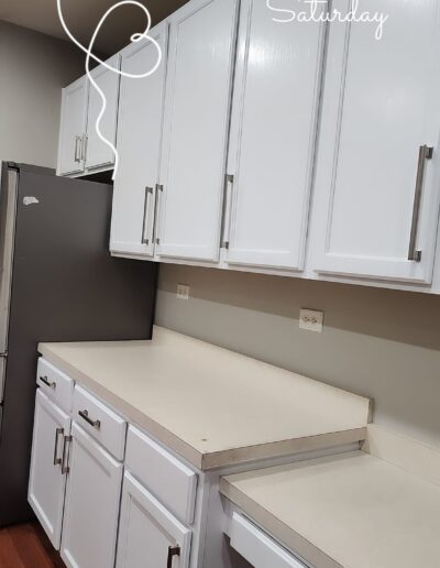 A kitchen with white cabinets and stainless steel appliances.